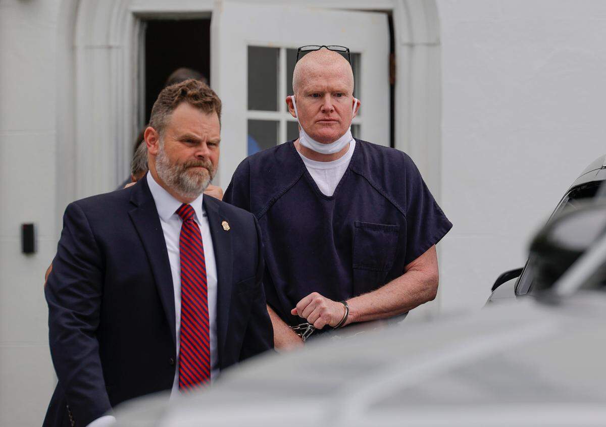 Alex Murdaugh is escorted from the Colleton County Courthouse after a judicial hearing before Judge Clifton Newman on Monday, Aug. 29, 2022.