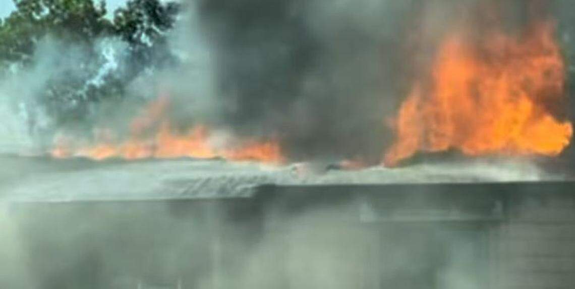 Fire shoots through the roof of condominiums.