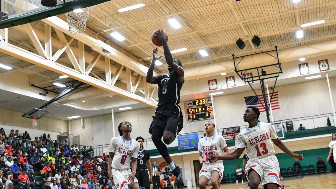 Gray Collegiate's Jalek Felton (5) goes up an uncontested dunk during his MLK Bash game against A.C. Flora. Felton would end the game with a total of 41 points over his Flora rivals.
