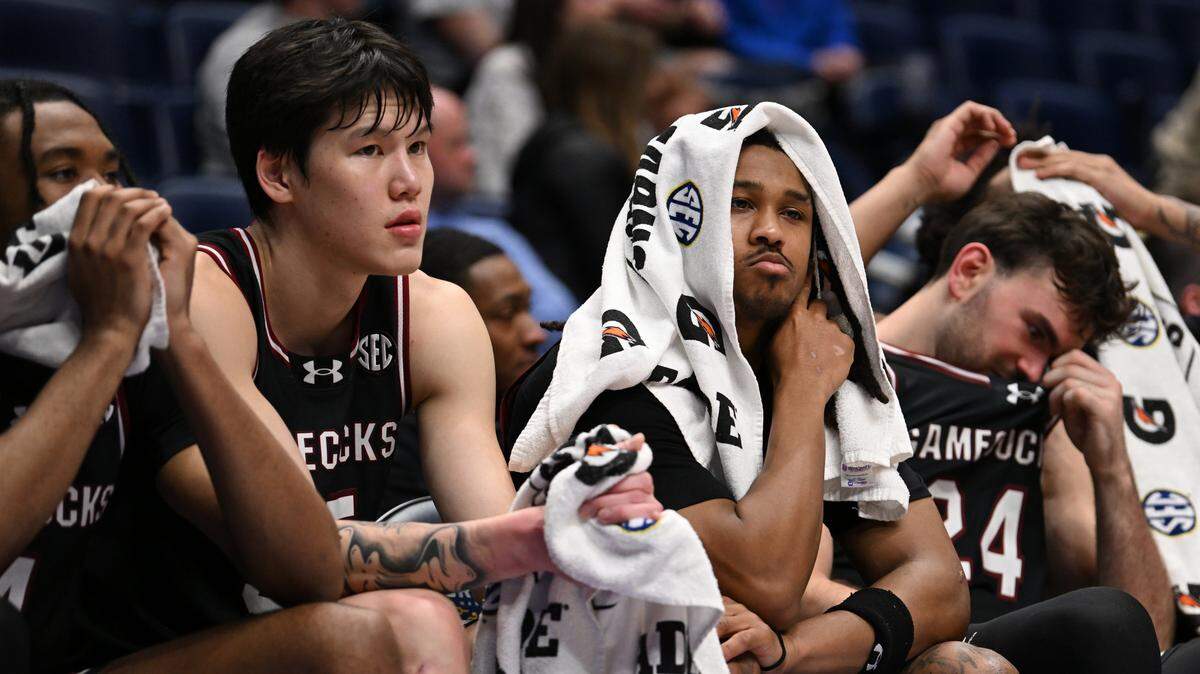 Mike Sharavjamts #55 and Meechie Johnson #5 of the South Carolina Gamecocks react from the bench during the second half against the Oklahoma Sooners in the first round of the 2026 SEC Men's Basketball Tournament at Bridgestone Arena on March 11, 2026 in Nashville, Tennessee.