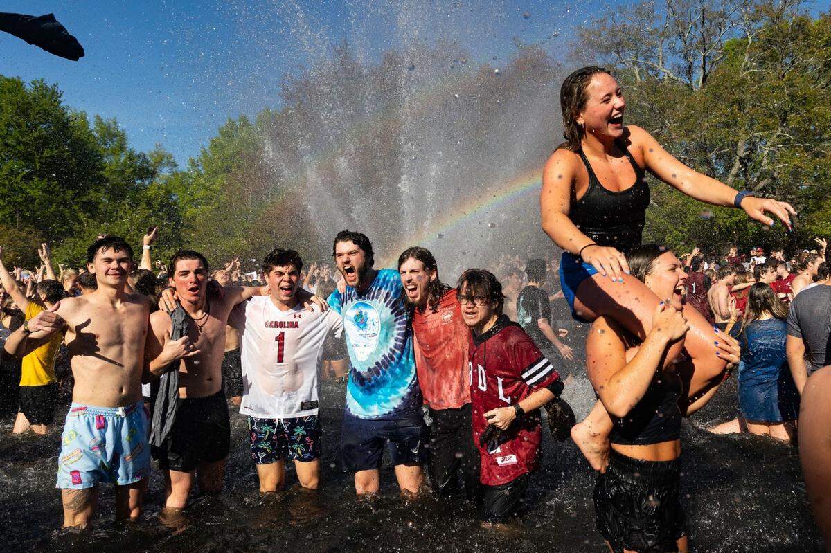 University of South Carolina students celebrate on campus Sunday in the fountain in front of the Thomas Cooper Library after the Gamecocks women’s basketball team’s national championship win over Iowa.
