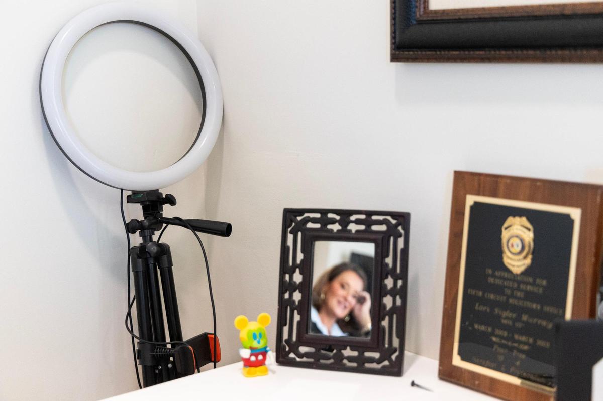 Lori Murray, a personal injury and criminal defense lawyer who’s news and legal analysis has won her TikTok fame, at her office on Thursday, October 19, 2023. Her gear for filming her TikTok videos leans against the wall near awards and mementos from her career as a lawyer.