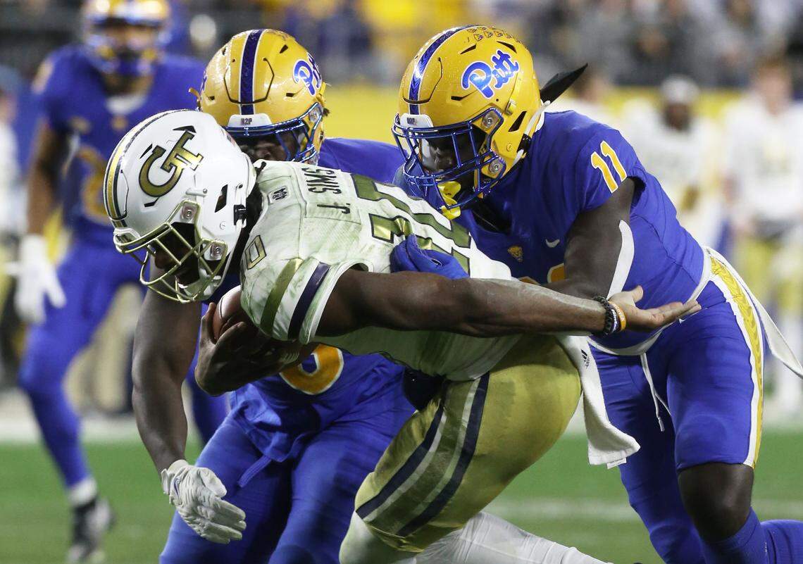 Pittsburgh Panthers defensive lineman Calijah Kancey (8) and linebacker Bangally Kamara (11) sack Georgia Tech Yellow Jackets quarterback Jeff Sims (10) in 2022.