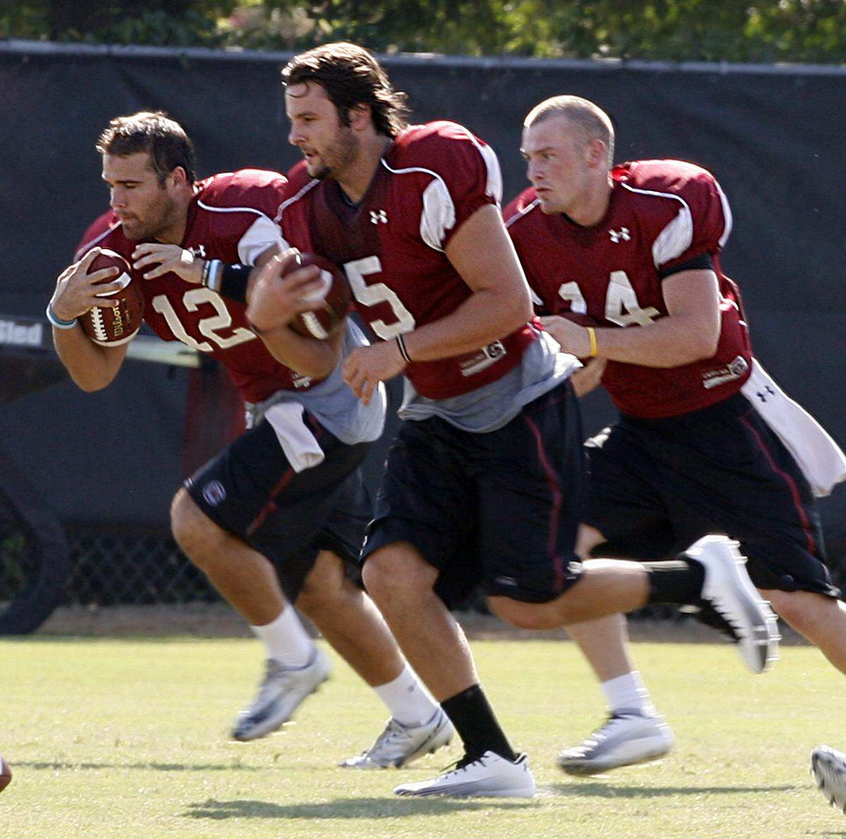 USC quarterbacks Andrew Clifford, Stephen Garcia and Connor Shaw run drills during a 2010 practice.
