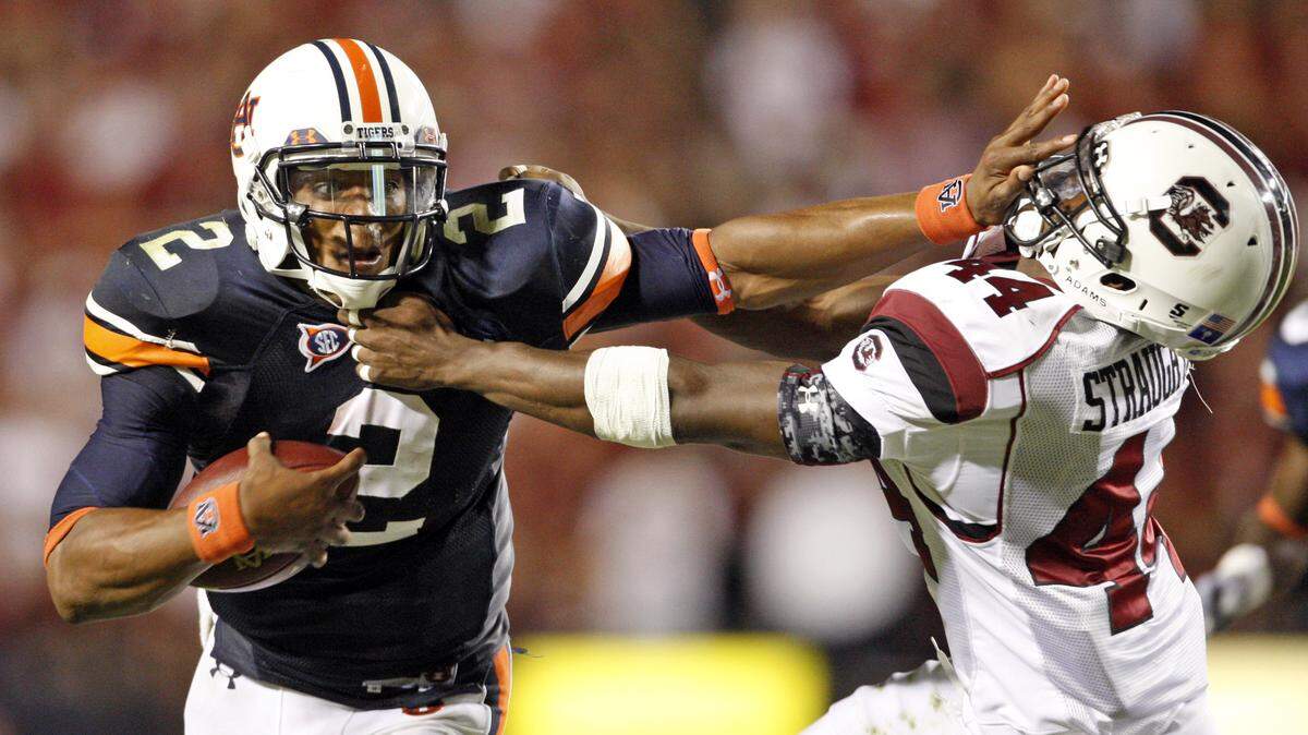 Auburn quarterback Cam Newton stiff-arms USC linebacker Tony Straughter during the Gamecocks' loss to the Tigers on Sept. 25, 2010.