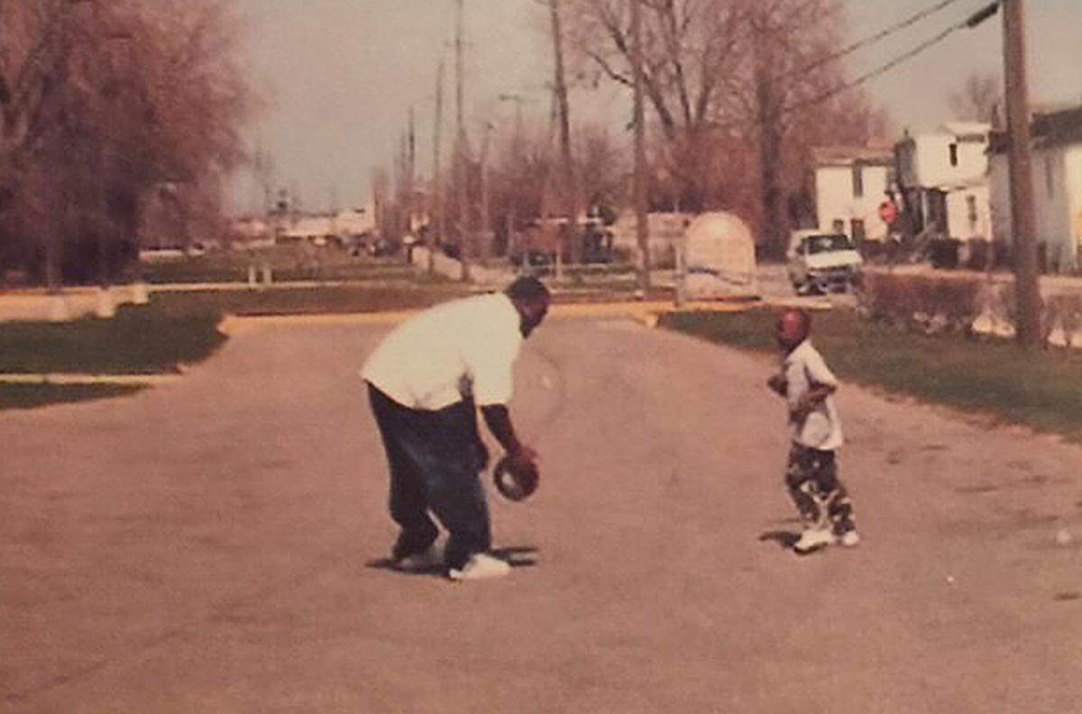 Jermaine Couisnard at a young age, learning the game of basketball with his father in their east Chicago neighborhood.