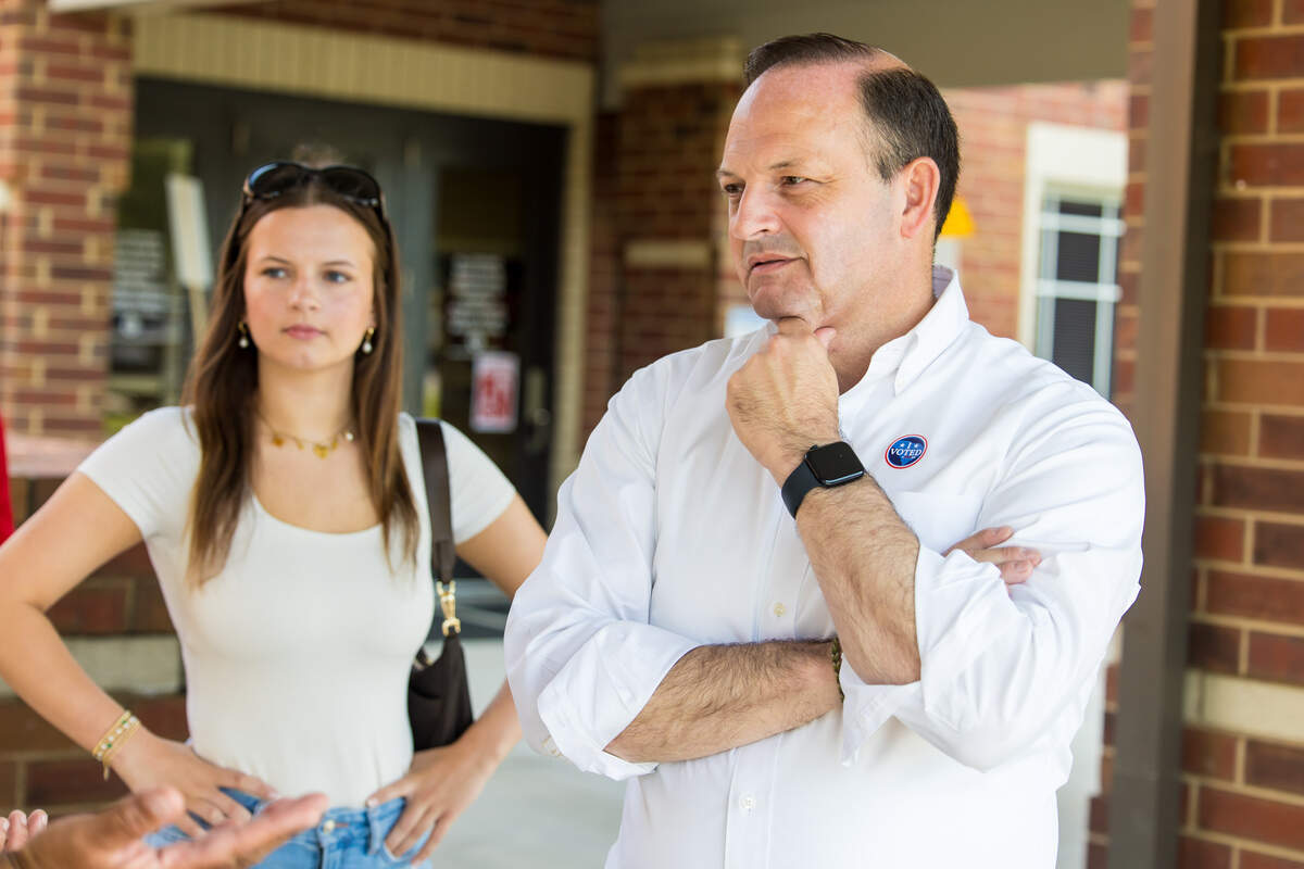 Attorney General Alan Wilson, Republican candidate for Governor, gives an interview after voting at New Providence Elementary School in Lexington, SC, the morning of 6/9/26. His daughter Anna Grace Wilson listens in the background.