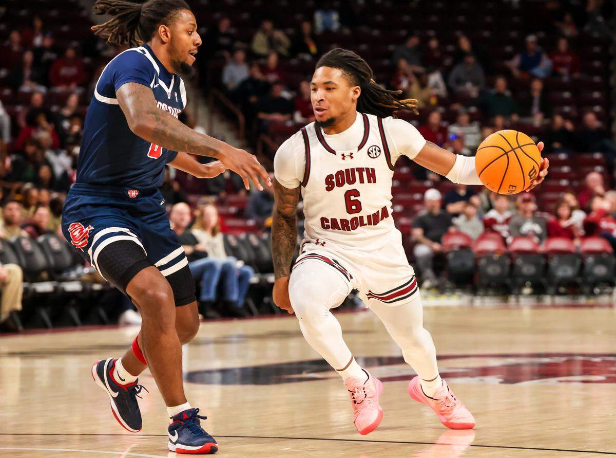 South Carolina Gamecocks guard Jamarii Thomas (6) drives around Radford Highlanders guard Brandon Maclin (0) in the first half at Colonial Life Arena.