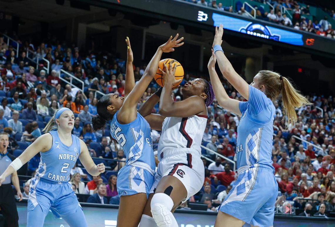 South Carolina’s Aliyah Boston (4) shoots as North Carolina’s Deja Kelly (25) and North Carolina’s Alyssa Ustby (1) pressure during the second half of action during the Sweet 16 game at the Greensboro Coliseum on Friday, March 25, 2022.