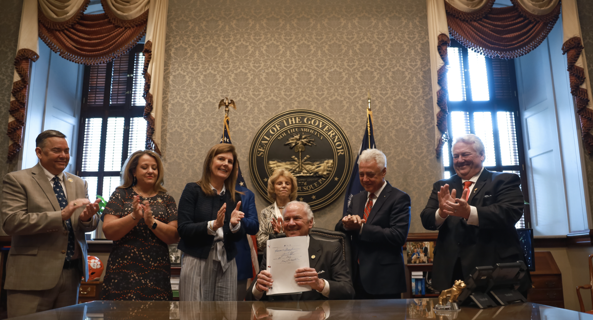 S.C. Gov Henry McMaster, center, signed S. 474, a six-week abortion ban, into law. He was joined by, from left, state Rep. John McCravy, R-Greenwood; state Rep. Melissa Oremus, R-Aiken; S.C. Lieutenant Gov. Pamela Evette; first lady Peggy McMaster; state Sen. Larry Grooms, R-Berkeley; and state Sen. Billy Garrett, R-McCormick.