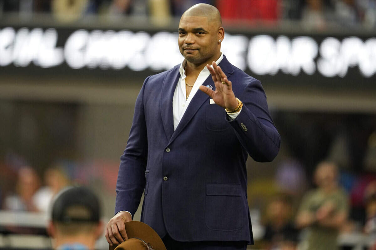 Richard Seymour waves while being honored for the Pro Football Hall of Fame during the first half of the NFL Super Bowl 56 football game between the Los Angeles Rams and the Cincinnati Bengals Sunday, Feb. 13, 2022, in Inglewood, Calif.