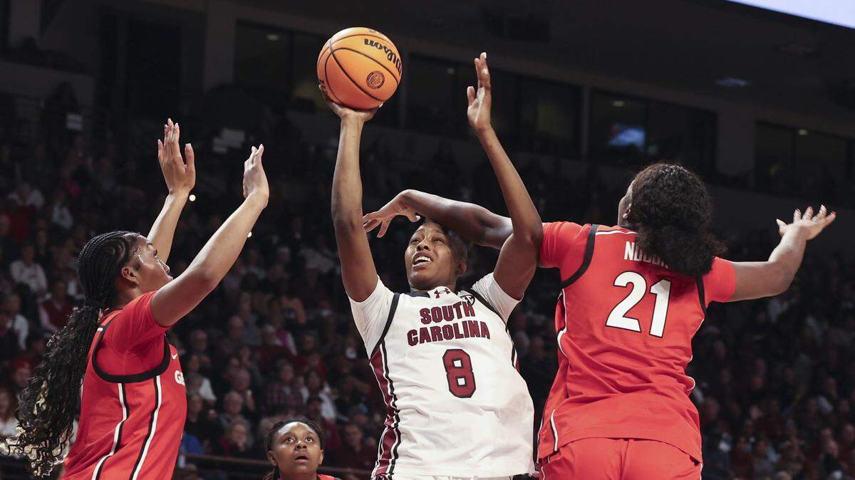 Georgia's Aicha Ndour (21) fouls on South Carolina's Joyce Edwards (8) during the first half of action of their women's basketball game against Georgia at Colonial Life Arena on Sunday, Jan. 11, 2026.