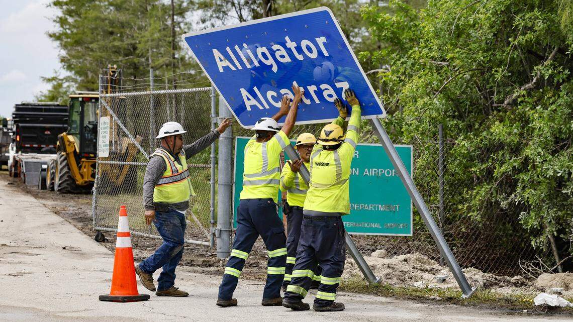 Workers install a permanent Alligator Alcatraz sign, in Collier County, Florida, on Thursday, July 3, 2025. (Al Diaz/Miami Herald/TNS)