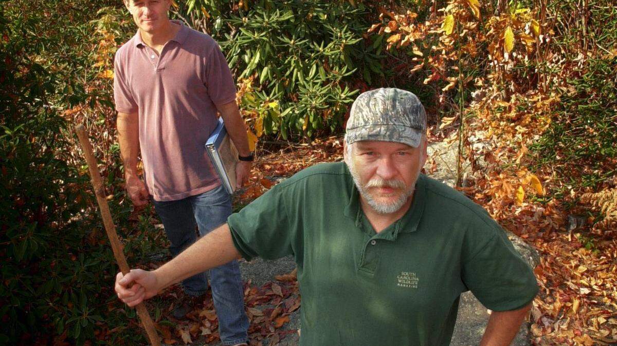 Dennis Chastain, (R) an outspoken upstate resident, and Wes Cooler stand on Sassafras Mountain in 2000. Chastain and Cooler helped protect the mountain top. Chastain died in November 2025.