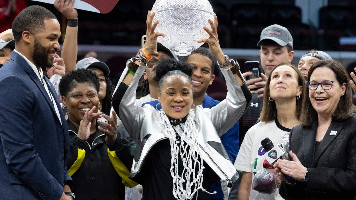 University of South Carolina Head Coach Dawn Staley lifts the WBCA Coaches’ Trophy after winning the National Championship against Iowa at the Rocket Mortgage FieldHouse in Cleveland, Ohio for the National Championship game against Iowa on Sunday, April 7, 2024.