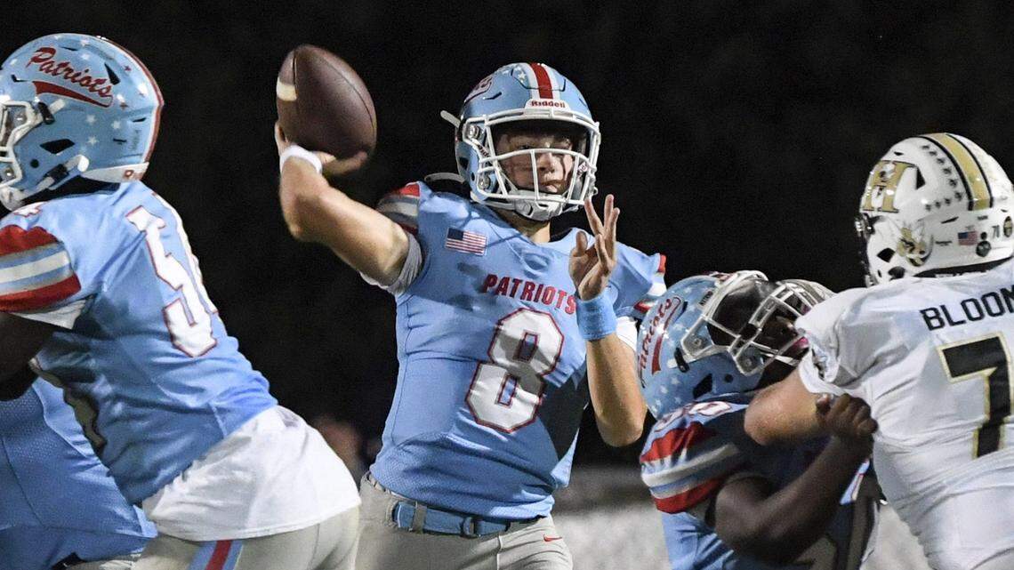 J.L. Mann’s Ethan Anderson (8) passes near TL Hanna’s Brooks Bloomer (70) during the second quarter in Greenville, S.C. Friday, October 6, 2023.