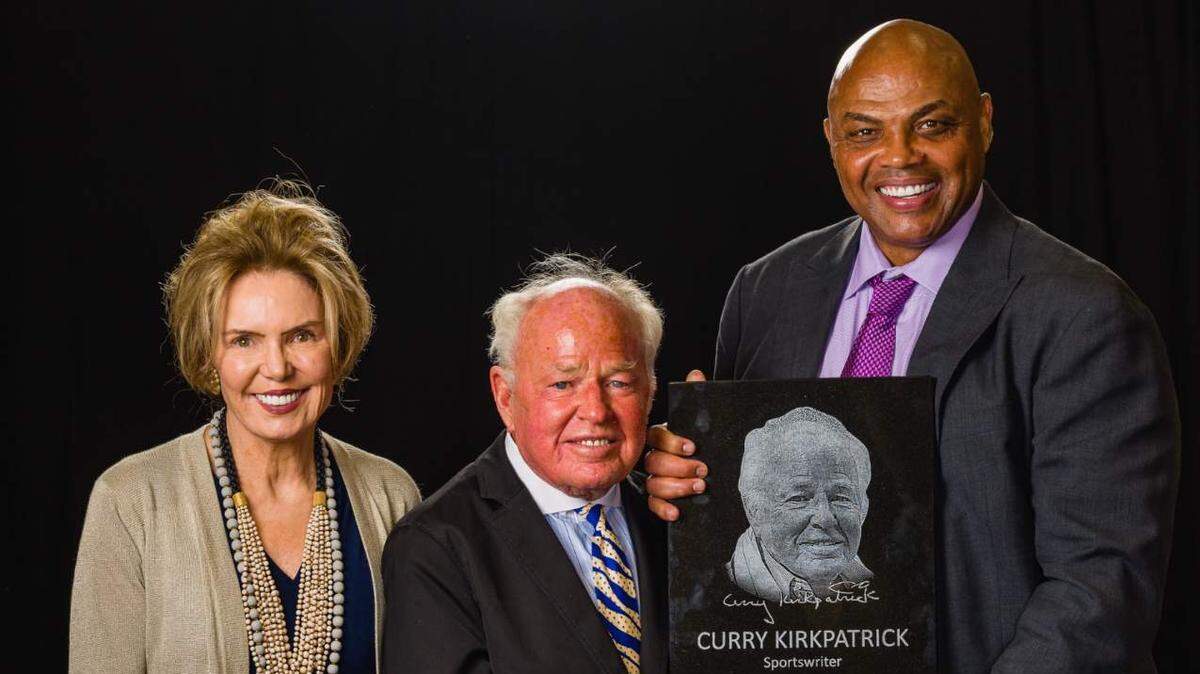 Hilton Head’s Curry Kirkpatrick poses with his hall of fame plaque with presenters Lesley Visser and Charles Barkley.