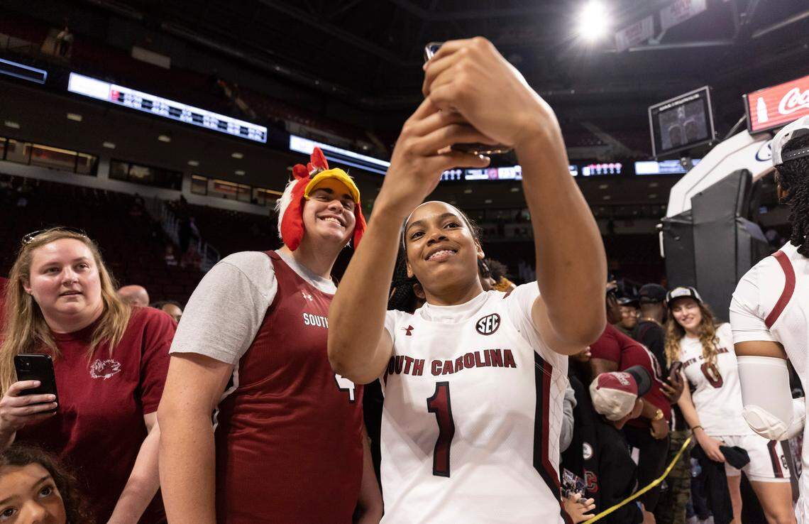 South Carolina Gamecocks guard Zia Cooke (1) takes a photo with a fan following South Carolina’s game against the visiting Bulldogs at Colonial Life Arena in Columbia on Sunday, February 26, 2023.