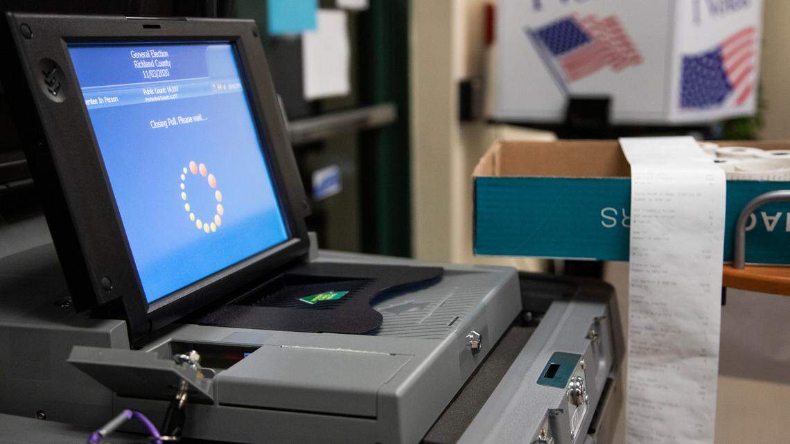 A machine processes votes from a flash drive and prints the results at an election polling site in this 2020 file photo.