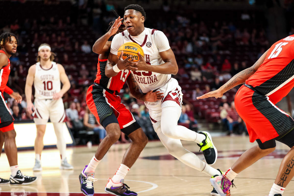 South Carolina Gamecocks forward Gregory Jackson II (23) drives around Georgia Bulldogs guard Mardrez McBride (13) in the first half at Colonial Life Arena.