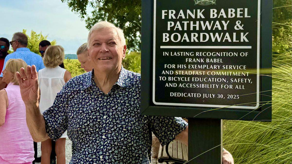 Frank Babel poses with a newly unveiled marker naming part of Hilton Head Island’s pedestrian and bike path system for him on Wednesday, July 30, 2025.