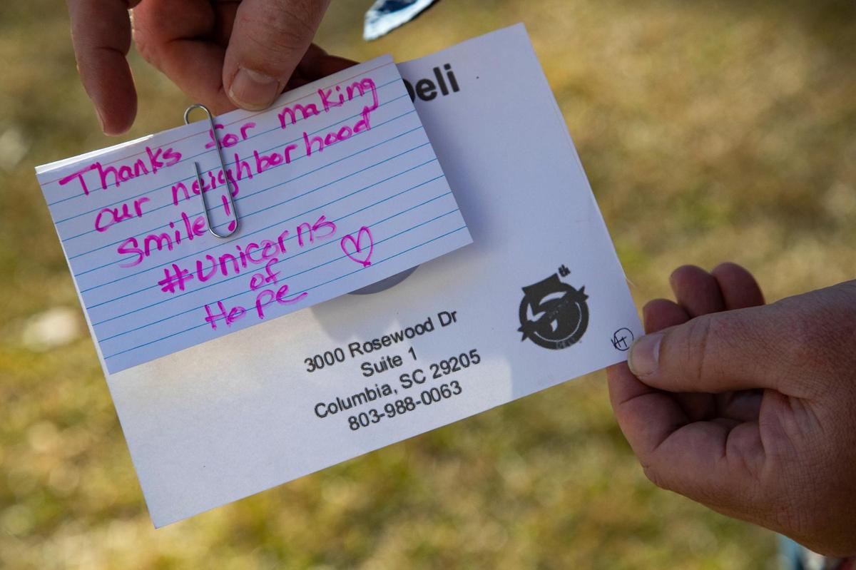 Ed McDonnell shows a not received from a neighbor about the unicorn display in front of their home in Columbia, South Carolina on Thursday, January 14, 2021.