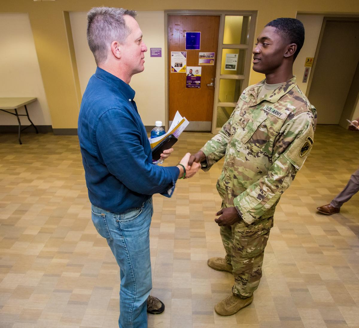 Democratic gubernatorial candidate James Smith, left, speaks with Army soldier David Laurie during a town hall meeting at Benedict College.