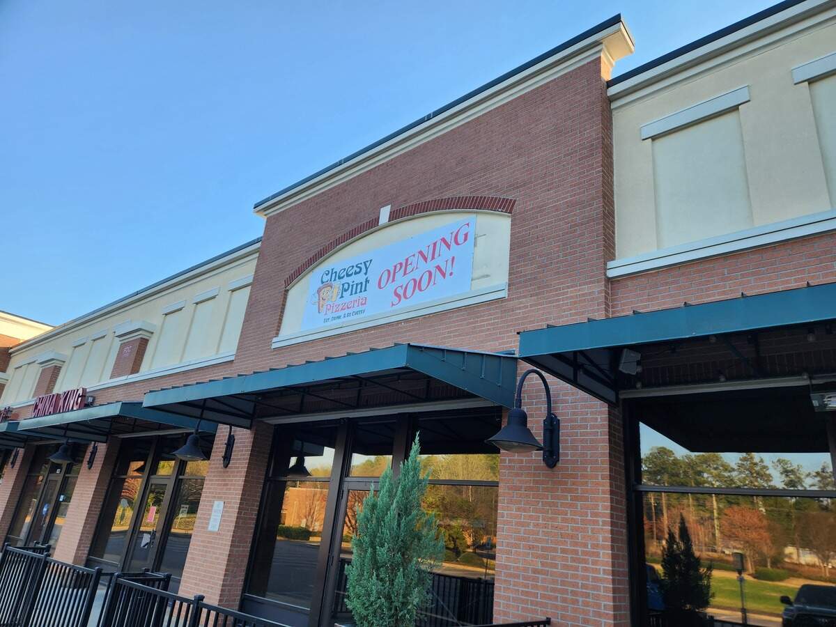 A banner announcing Cheesy Pint Pizzeria is coming soon hangs at the Murray Landing shopping center on North Lake Drive near Irmo.