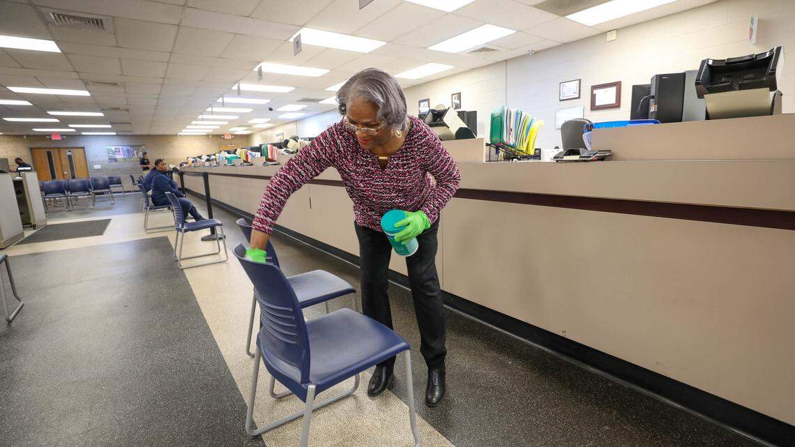 Maurine Boyles, as assistant manager at the Shop Road branch of The South Carolina Department of Motor Vehicles, cleans chairs between people. The modified how they help customers during the coronavirus pandemic. On Monday, the SCDMV will resume in-car road tests at all of its branches and return to other pre-pandemic operations.