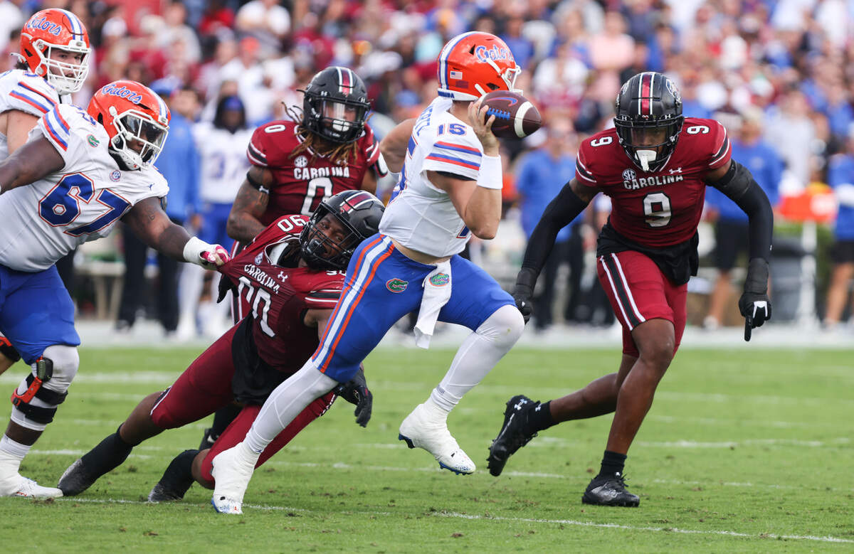 South Carolina defensive tackle T.J. Sanders (90) and defensive end Desmond Umeozulu (9) move in on Florida quarterback Graham Mertz (15) during the first quarter of South Carolina’s game at Williams-Brice Stadium in Columbia on Saturday, October 14, 2023.