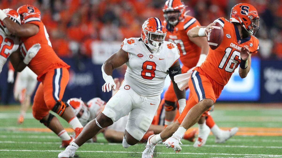 Clemson defensive tackle Tre Williams (8) chase Syracuse quarterback Garrett Shrader (16) during the first quarter of an NCAA football game in Syracuse, N.Y., Friday, Oct. 15, 2021. (AP Photo/Joshua Bessex)