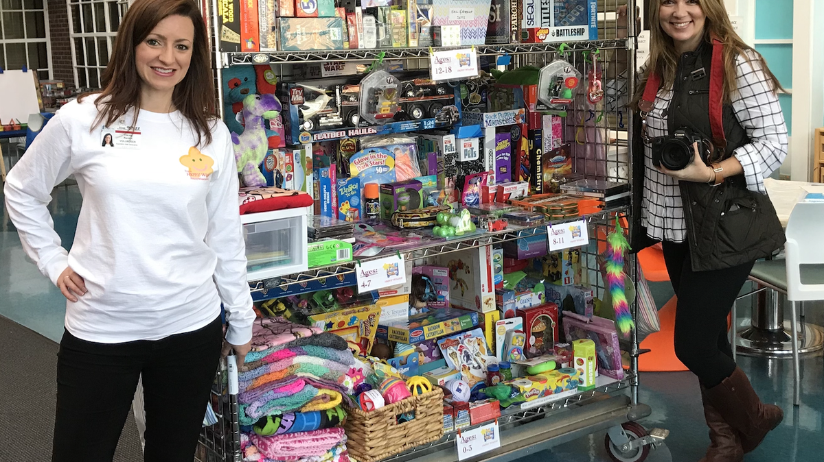 Tracey Rankin, left, and volunteer Liz Barnes, deliver toys and books to children in a South Carolina children’s hospital.