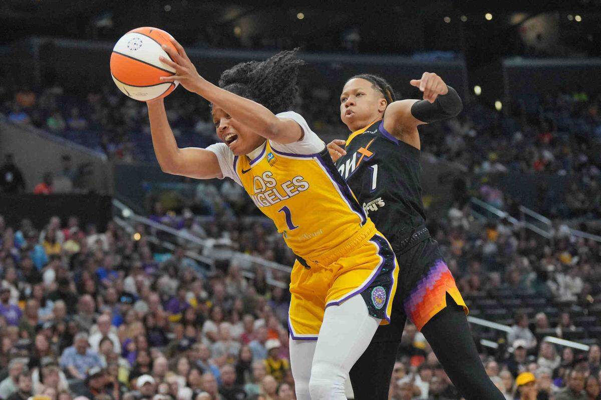LA Sparks guard Zia Cooke (left) is fouled by Phoenix Mercury guard Sug Sutton in a July 7 game.