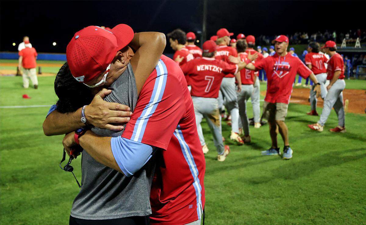 AC Flora coach Andy Hallett shares a long embrace with girlfriend Lisa Hernandez in the moments after the Falcons' 2026 Class 4A state championship win over Airport on Friday, May 29..
