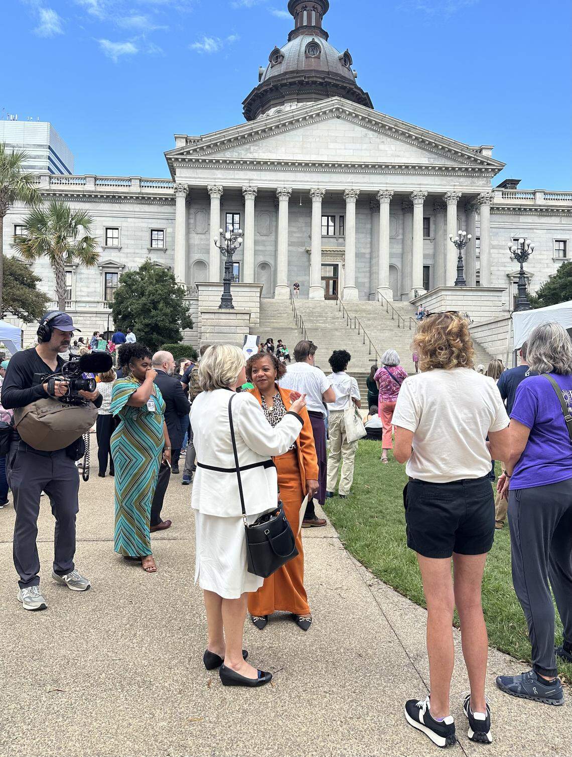 State Sen. Tameika Isaac Devine, D-Richland, talks to former Republican state Sen. Penry Gustafson after a morning of testimony on a near total abortion ban Wednesday, Oct. 1, 2025 in Columbia