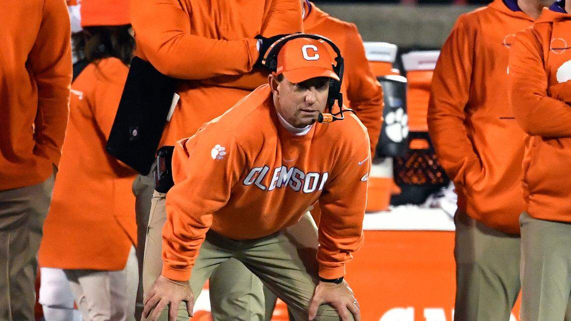 Clemson coach Dabo Swinney, center, watches during the second half of the team’s NCAA college football game against Louisville in Louisville, Ky., Saturday, Nov. 6, 2021. Clemson won 30-24. (AP Photo/Timothy D. Easley)