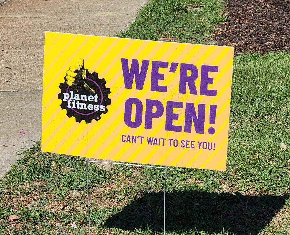 A sign announces that the new Planet Fitness location in West Columbia, SC on Augusta Road is now open.