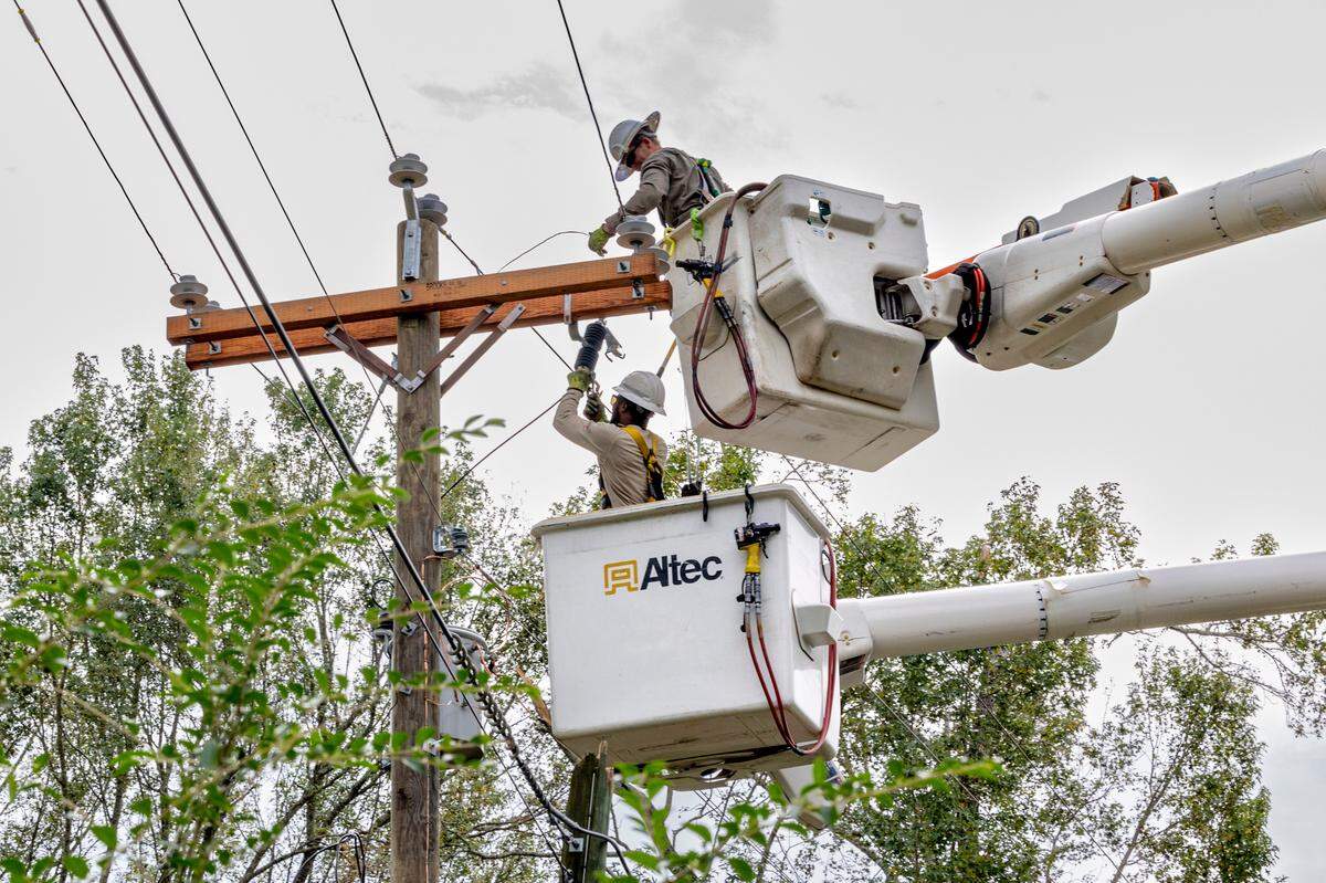 Linemen Garret Hammond, top, and Kord Williams, and from Aiken Electric Cooperative, repair downed power lines in Edgefield on Tuesday, Oct. 1, 2024. High winds from Hurricane Helene toppled trees leaving thousands without power. The damage to rural areas is so bad that along many roads, the entire electrical infrastructure needs to be rebuilt.