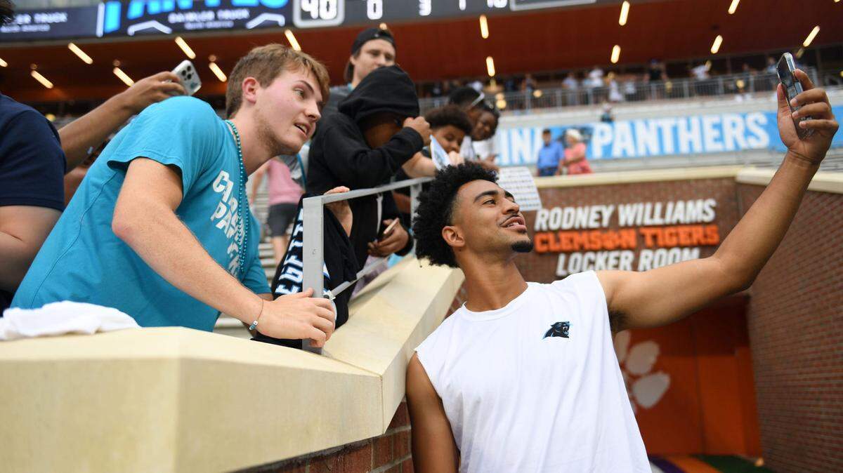 Carolina Panthers quarterback Bryce Young (9) takes a photo with fan, Carson Dixon, 19, at Memorial Stadium at Clemson University during the Panthers Fan Fest in Clemson, S.C., on Thursday, Aug. 1, 2024.