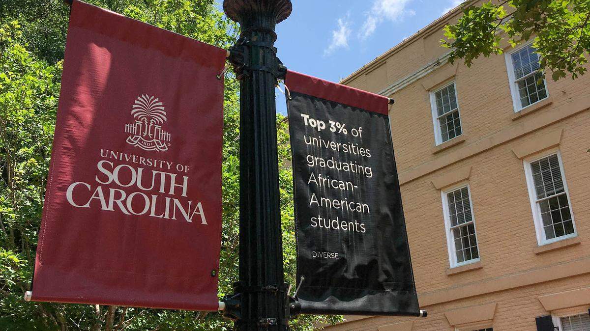 Signs are posted along The Horseshoe on the University of South Carolina campus in Columbia, SC July 9, 2021.