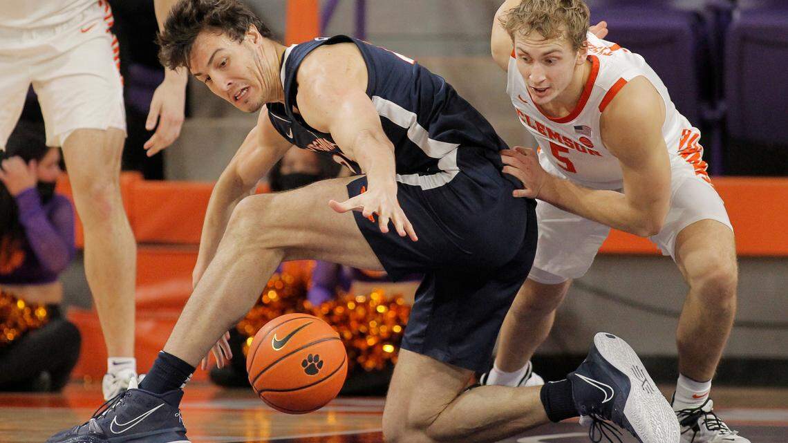 Virginia center Francisco Caffaro (22) loses the ball as Clemson forward Hunter Tyson (5) looks on during first-half action in Clemson, S.C. on Tuesday, Jan. 4, 2022.