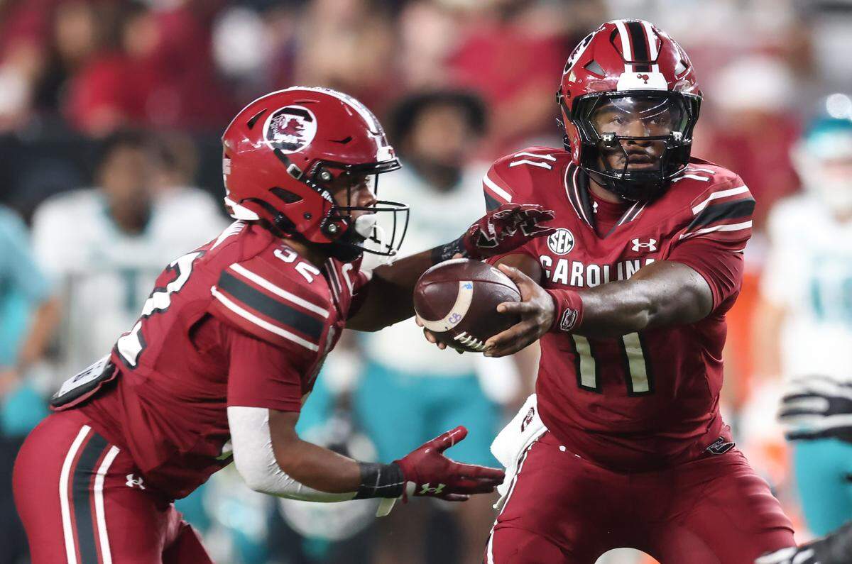South Carolina quarterback Air Noland (11) hands off the ball to fullback Bradley Dunn (32) during second half of the Gamecocks’ game against Coastal Carolina at Williams-Brice Stadium in Columbia on Saturday, November 22, 2025.