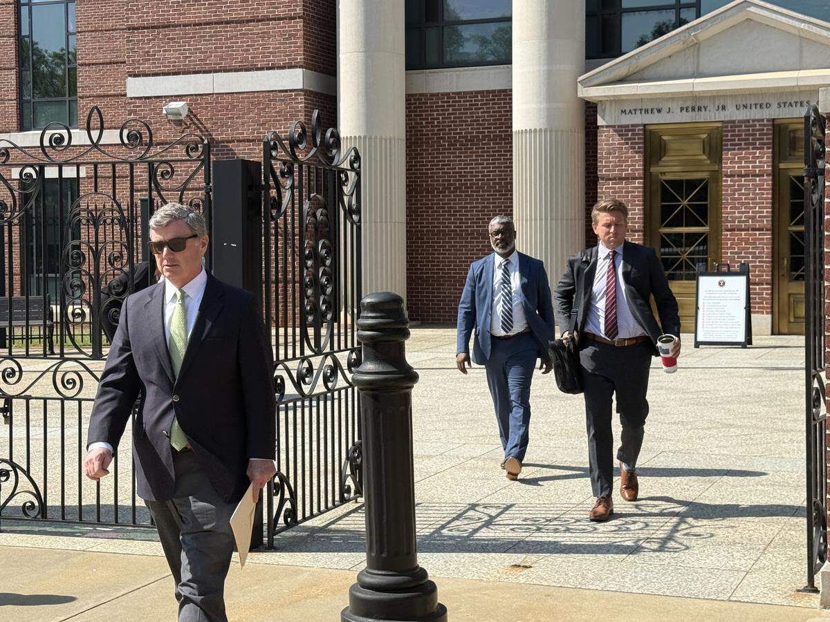 U.S. Attorney Bryan Stirling (left), and prosecutors DeWayne Pearson (center) and Elliott Daniels (right) leave the Columbia federal courthouse Friday after hearing embezzler Melodie Hoover get a six-year prison sentence.