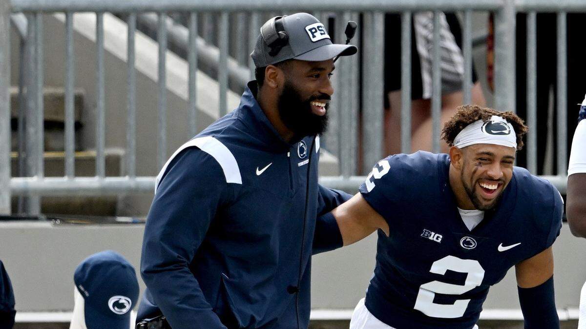 Penn State defensive line coach Deion Barnes (left)