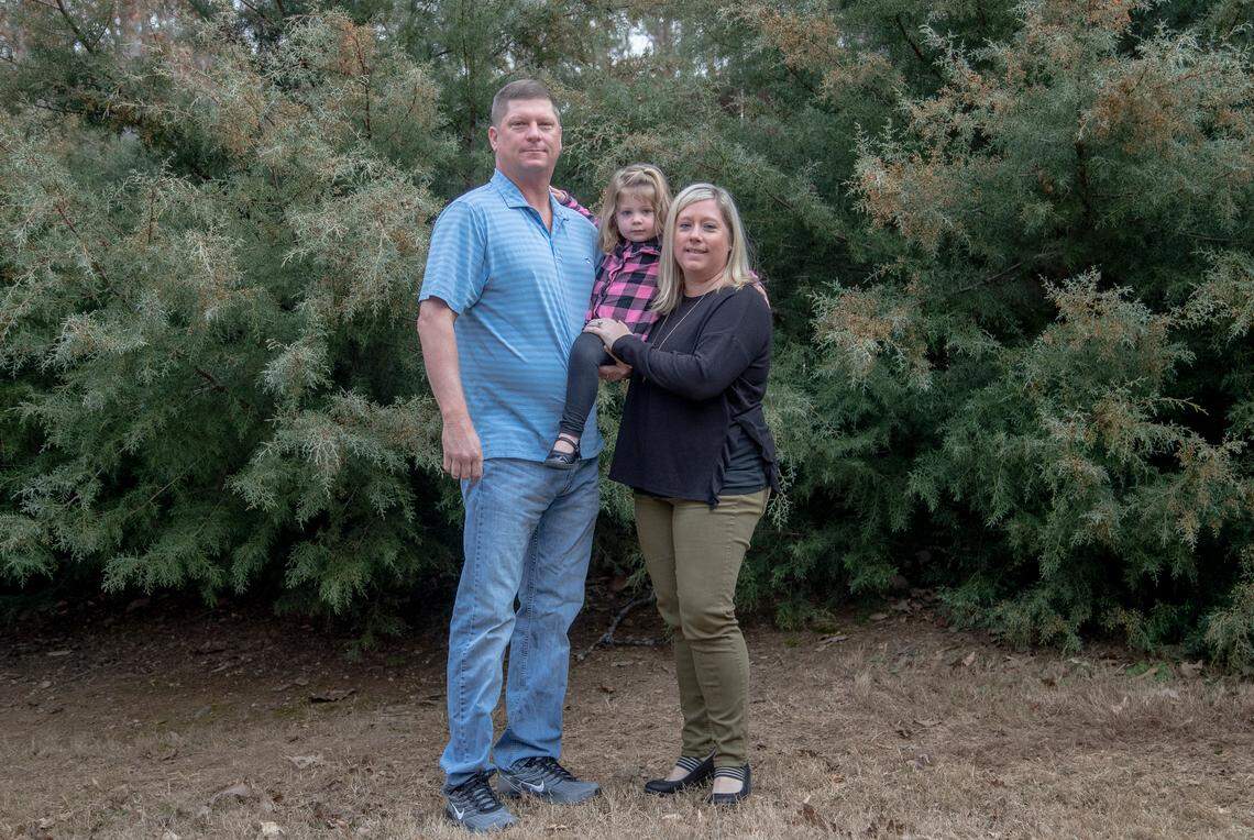 Frank and Kerri Gray hold their daughter, Bailey, 2, in their arms while in the backyard. In 2013, their son, Jackson, died from suffocation by bedding at 12 weeks old while staying in a home day care. In the wake of another infant’s death, a state law was passed allowing regulators, for the first time ever, to conduct unannounced inspections of these homes without needing a complaint.