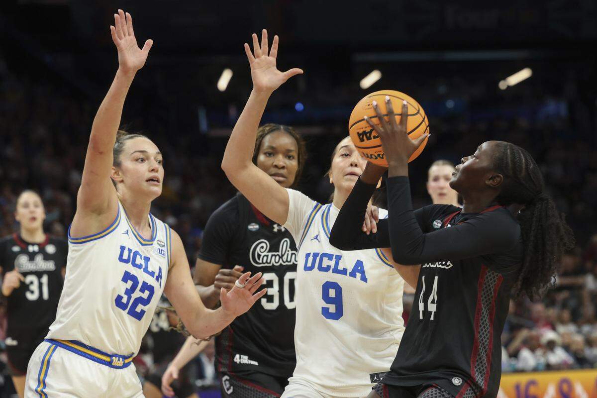 South Carolina's Agot Makeer (44) shoots as UCLA’s Angela Dugalić (32) and Lena Bilić (9) pressure during the second half of action of their women's basketball game for the NCAA national championship against UCLA at Mortgage Matchup Center in Phoenix on Sunday, April 5,2026.
