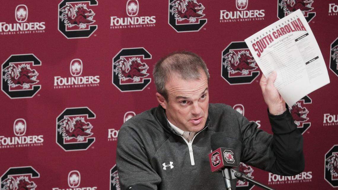 South Carolina Gamecocks head coach Shane Beamer holds up a list of recruits on Wednesday, December 15, 2021.