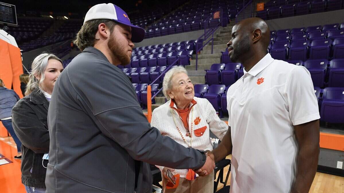 Clemson basketball fan Paula Grooms and her grandson Jag talk with Clemson assistant coach Kareem Richardson after the Tigers game against Pitt Saturday, January 22, 2022. Bart Boatwright/Special to The State