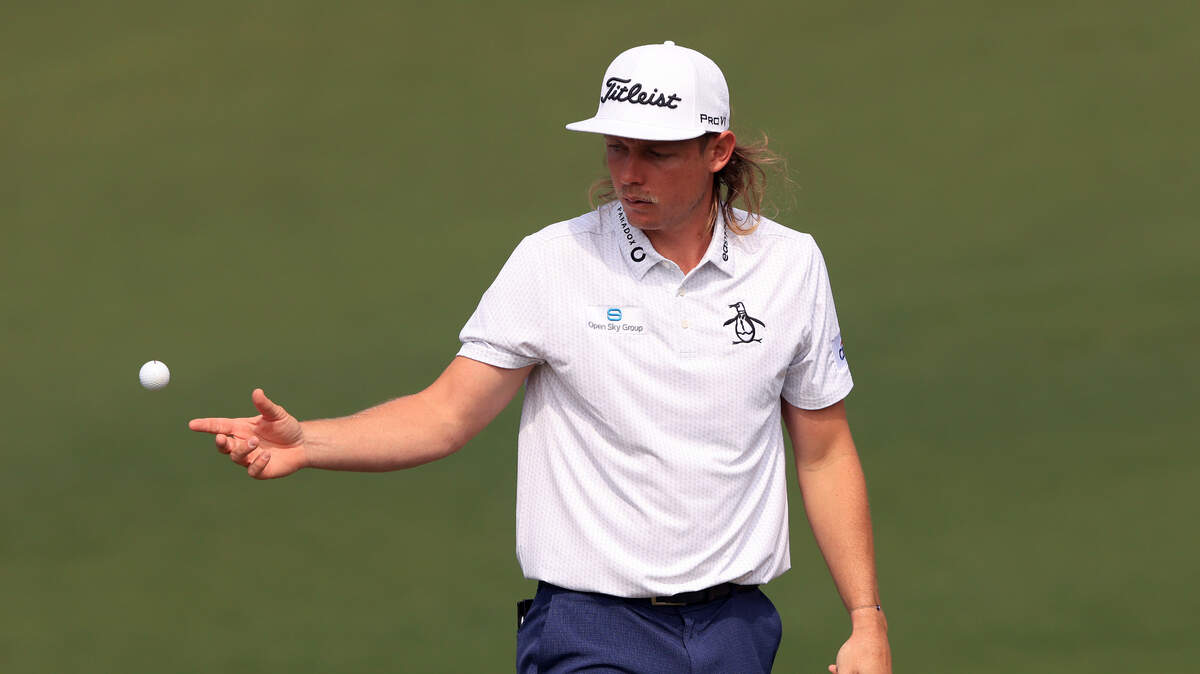 Cameron Smith of Australia handles his golf ball after putting on No. 2 during the first round of the Masters at Augusta National Golf Club, Thursday, April 7, 2022.