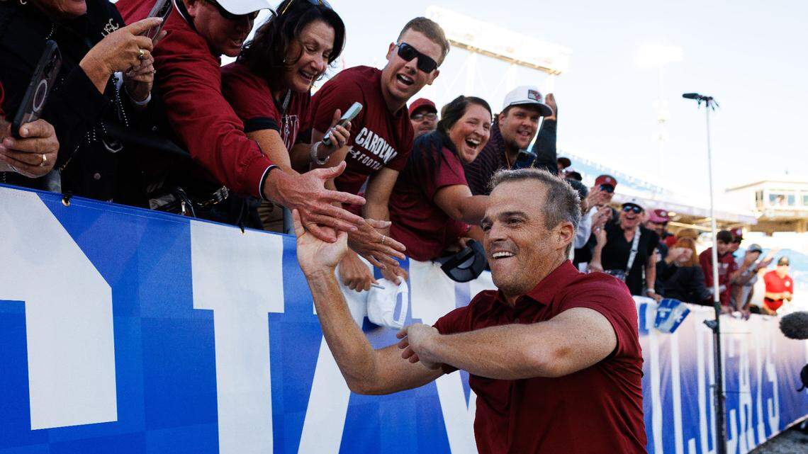 South Carolina Gamecocks head coach Shane Beamer high fives fans after the game against the Kentucky Wildcats at Kroger Field. Mandatory Credit: Jordan Prather-Imagn Images